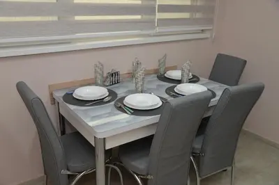 a dining room table with chairs and plates on it at Milivojevic in Soko Banja