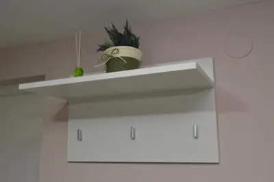 a white shelf with a potted plant on it at Milivojevic in Soko Banja
