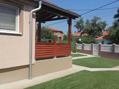 a wooden pergola on the side of a house at Milivojevic in Soko Banja