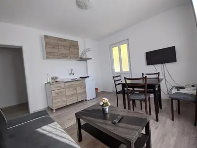 a living room with a couch and a table at Apartman IKA Sokobanja in Soko Banja