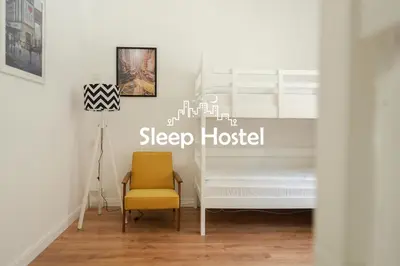 a bedroom with a bed and a yellow chair at Sleep Hostel in Niš