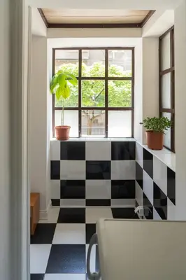 a room with a black and white checkered floor at Sleep Hostel in Niš