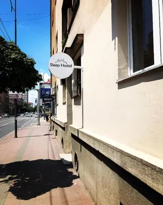 a sign on the side of a building at Sleep Hostel in Niš