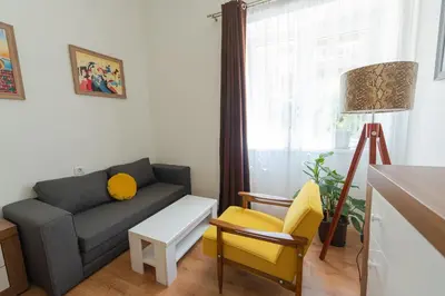 a living room with a couch and a chair at Sleep Hostel in Niš