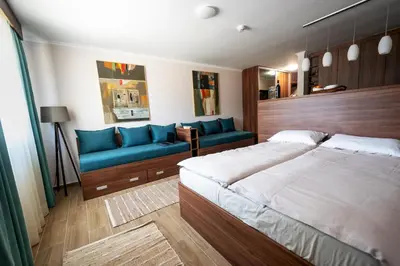 a bedroom with a bed and a blue couch at Dolce Vita in Kopaonik