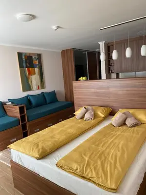 a bedroom with two beds and a blue couch at Dolce Vita in Kopaonik