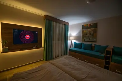 a bedroom with a bed and a tv on the wall at Dolce Vita in Kopaonik