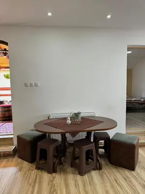 a table and some stools in a room at Apartman Zigic in Soko Banja