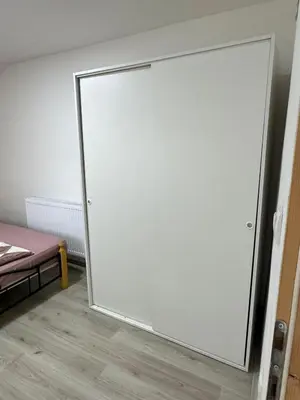 a sliding glass door in a room with a bed at Apartman Zigic in Soko Banja