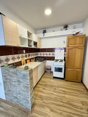 a kitchen with white cabinets and a stove top oven at Apartman Zigic in Soko Banja