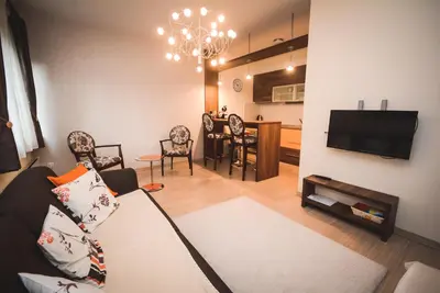 a living room with a couch and a tv at Apartment Ilunion I in Vrnjačka Banja