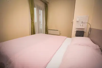 a bedroom with two white beds and a window at Apartment Ilunion I in Vrnjačka Banja
