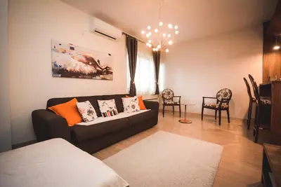 a living room with a couch and some chairs at Apartment Ilunion I in Vrnjačka Banja