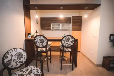 a kitchen with a table and chairs in a room at Apartment Ilunion I in Vrnjačka Banja