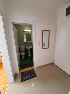 a small bathroom with a toilet and a sink at Le Soleil Apartman Vrnjačka Banja in Vrnjačka Banja