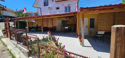a patio of a house with a fence at Dedovina in Soko Banja