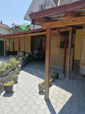 a wooden pergola with potted plants on a patio at Dedovina in Soko Banja