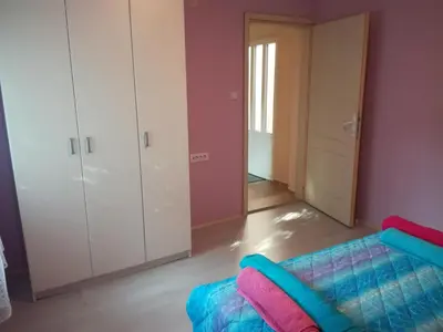 a living room with a couch and a closet at Apartman Aleks in Soko Banja