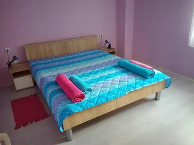 a bed with two pillows on it in a room at Apartman Aleks in Soko Banja