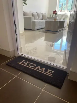 a door mat on the floor in a living room at Apartmani Bambi Sokobanja in Soko Banja