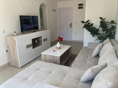 a living room with a couch and a tv at Apartmani Bambi Sokobanja in Soko Banja