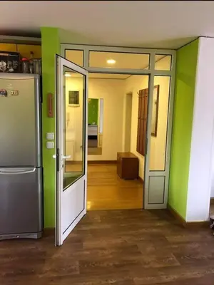 an open door to a room with green walls at Greenspace in Niš