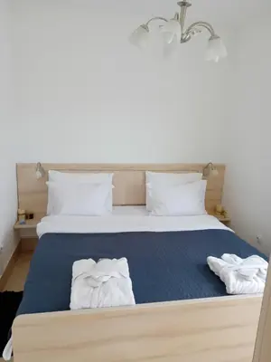 a bedroom with a bed with two towels on it at WING 3 apartman ,,BC ,, in Jagodina