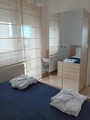 a room with two white towels on the floor and a mirror at WING 3 apartman ,,BC ,, in Jagodina