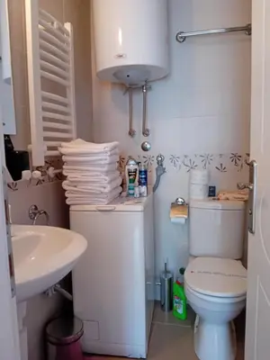 a small bathroom with a toilet and a sink at WING 3 apartman ,,BC ,, in Jagodina