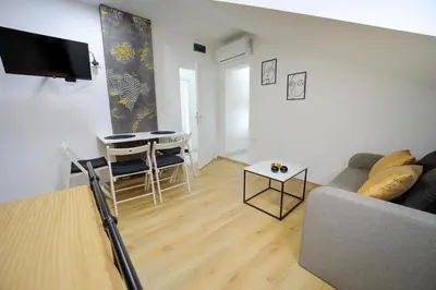 a living room with a couch and a table at Apartmani Hedonist in Soko Banja