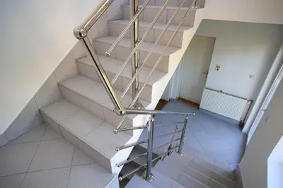 a set of stairs with a metal hand rail at Apartmani Hedonist in Soko Banja