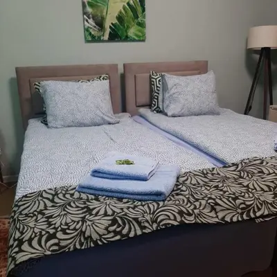 a bedroom with two beds with towels on them at Apartman Ana in Leskovac