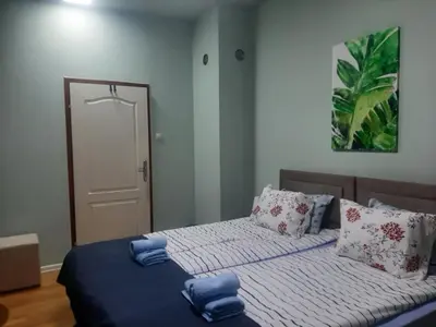 a bedroom with two beds with blue towels on them at Apartman Ana in Leskovac