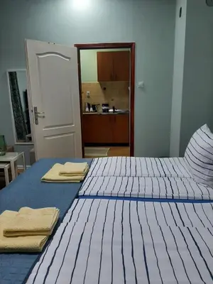 a bedroom with two beds with towels on them at Apartman Ana in Leskovac