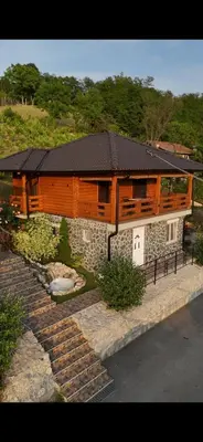 a house with a black roof and a stone path at Boja Zalaska - kameni apartman in Jagodina