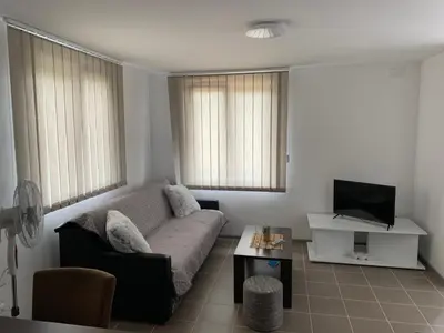a living room with a couch and a tv at Boja Zalaska - kameni apartman in Jagodina