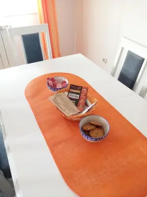 a table with a plate of food and a bowl of cookies at Apartman MACA in Pirot