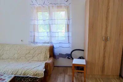 a small bedroom with a bed and a window at Šumska tajna - Radenkovac in Lipovac