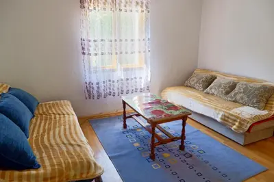 a living room with a couch and a coffee table at Šumska tajna - Radenkovac in Lipovac
