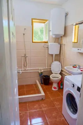a small bathroom with a toilet and a sink at Šumska tajna - Radenkovac in Lipovac