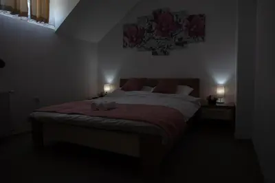 a bedroom with a bed with a stuffed animal on it at Restoran Mijajlovic in Kuršumlija