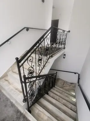 a staircase with a wrought iron railing in a house at Restoran Mijajlovic in Kuršumlija