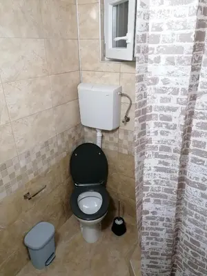 a bathroom with a toilet and a trash can at Studio sa francuskim i pomoćnim ležajem - Romansa in Ribarska Banja