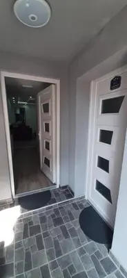 an empty room with a door and a hallway at Adrijana 2 Apartmani in Vrnjačka Banja