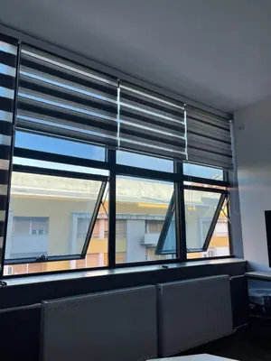 a room with a window with blinds on it at Enjoyment Apartment in Niš