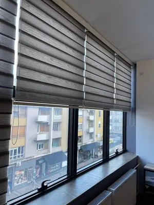 a room with a window with a window shade at Enjoyment Apartment in Niš
