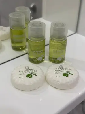a white table with three bottles of oil on it at Apartmani Joja in Kuršumlija