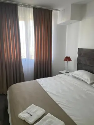 a bedroom with a bed with two towels on it at Apartmani Joja in Kuršumlija