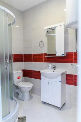 a bathroom with a toilet and a sink and a mirror at Sky Lux in Soko Banja