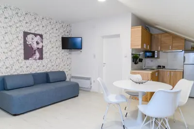 a living room with a couch and a table and chairs at Sky Lux in Soko Banja